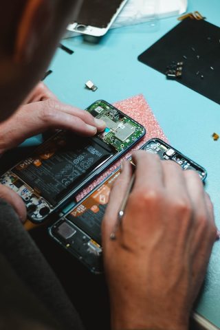 person repairing electronics - right to repair