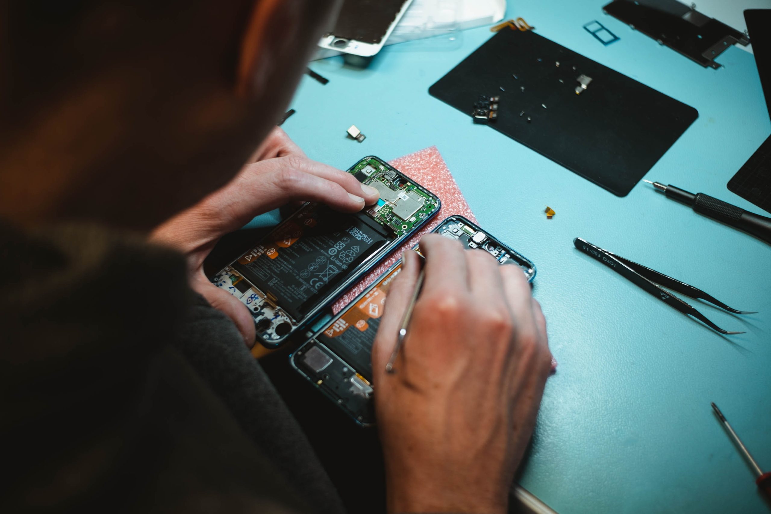 person repairing electronics - right to repair