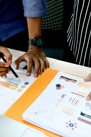 view of two hands reviewing data - Sustainability Data