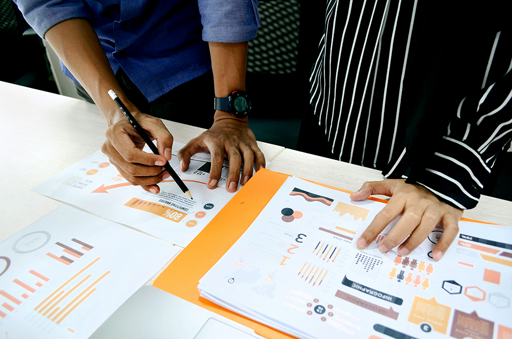 view of two hands reviewing data - Sustainability Data